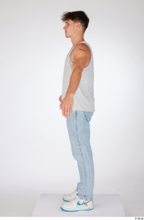 Darren a-poses blue jeans casual dressed grey tank top standing…